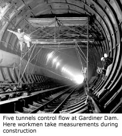 Five tunnels controll flow at Gardiner Dam.  Here workman take measurements during construction