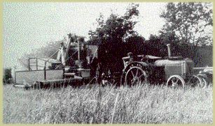 pic of combine pulled by tractor