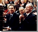 Prime Minister Chrtien applauds visiting British Prime Minister Tony Blair in the House of Commons (Ottawa).
