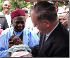 Prime Minister Chrtien with a newborn in Bamishi Village, Nigeria.