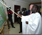 Prime Minister Chrtien looking at a map of literacy rates in Senegal at the Centre National de Ressources Educationnelles in Dakar.