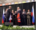 Prime Minister Chrtien and Russian President Vladimir Putin exchange hockey jerseys at a Team Canada 2002 signing ceremony in  Moscow.