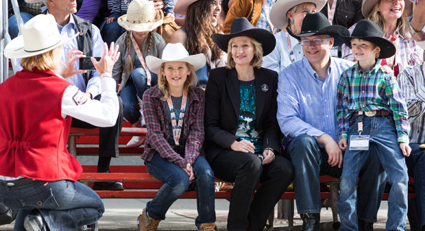 Prime Minister Stephen Harper and his wife Laureen take a photo with Jack Robinson and Morley Birdsell-Farrow during the Opening Parade at the Calgary Stampede.