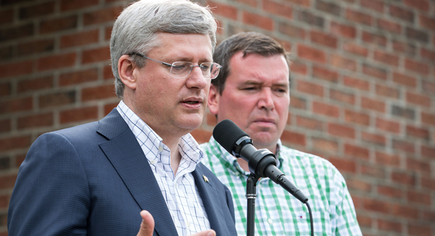Prime Minister Stephen Harper, accompanied by Christian Paradis, Minister of Industry and Minister of State (Agriculture), answers questions from the media.