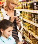 two people reading labels on a jar of food